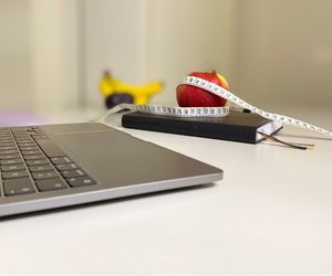 Laptop, fruit with soft measuring tape